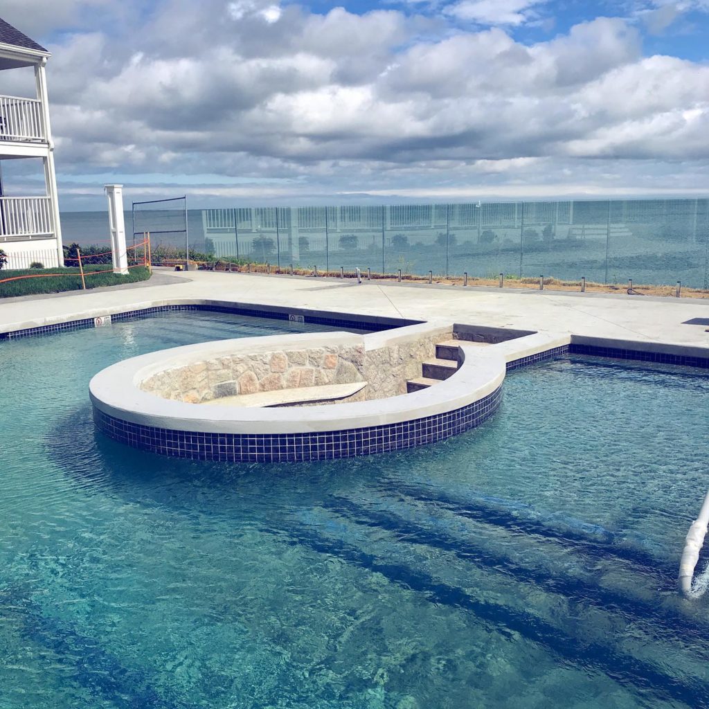 A pool with circular inset seating area constructed by Cooper Landscaping