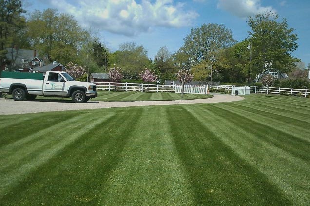 Cooper Landscaping truck with a perfectly mowed lawn